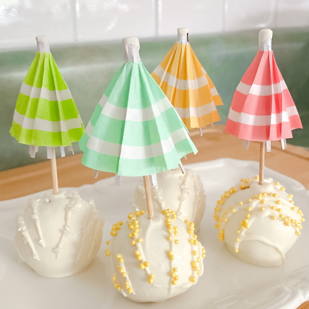 Lemon cake pops topped with colored umbrella picks.