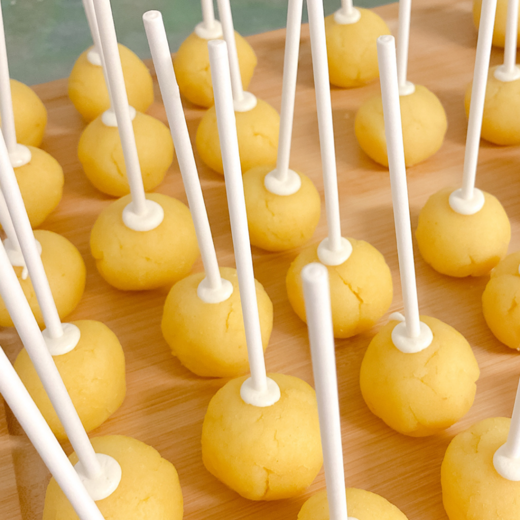 Cake pop dough balls with cake pop sticks.