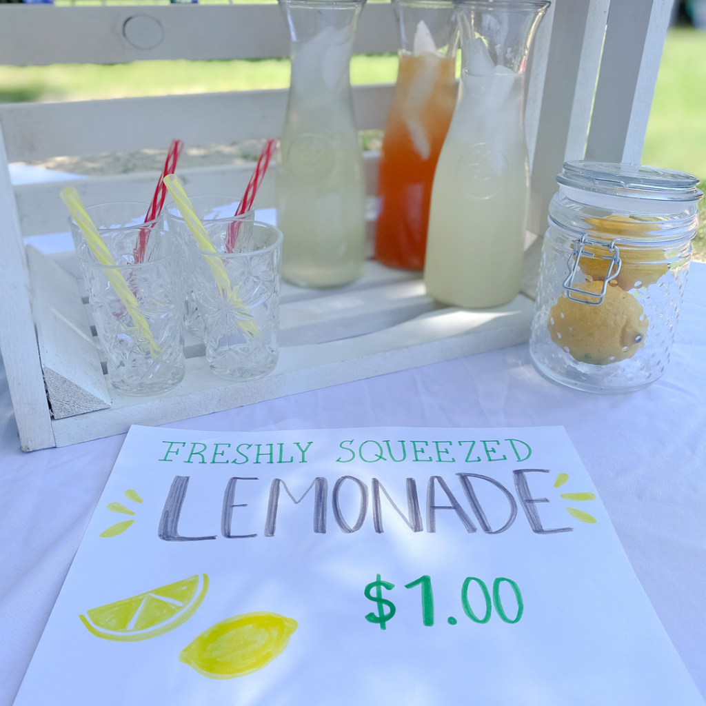 Lemonade Stand on white crate with lemonade stand sign