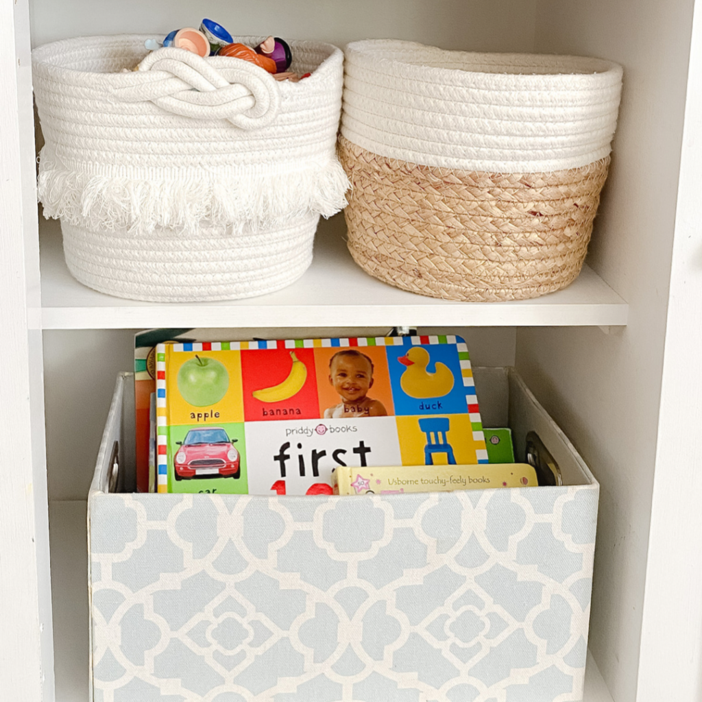 blue toy storage bin containing books. Toy storage baskets.