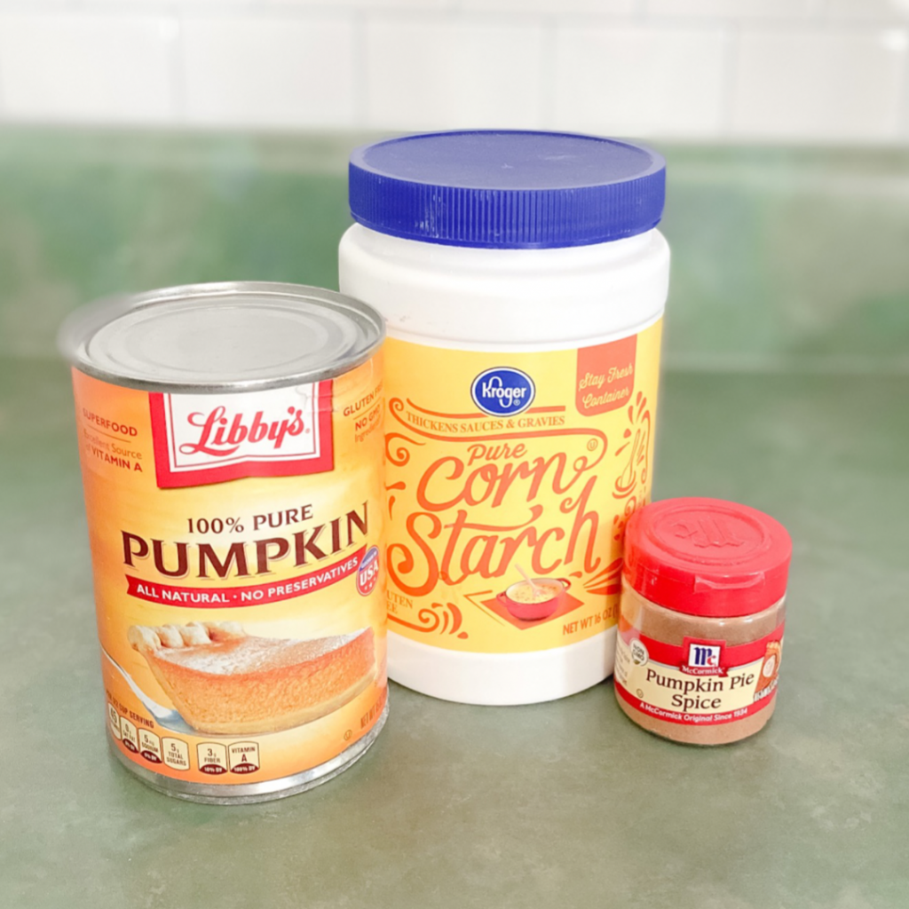 pumpkin puree corn starch and pumpkin pie spice on a green counter top
